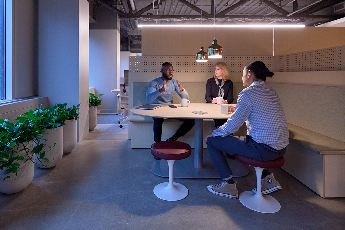 Morningstar employees collaborating in a small group discussion in a shared workspace.