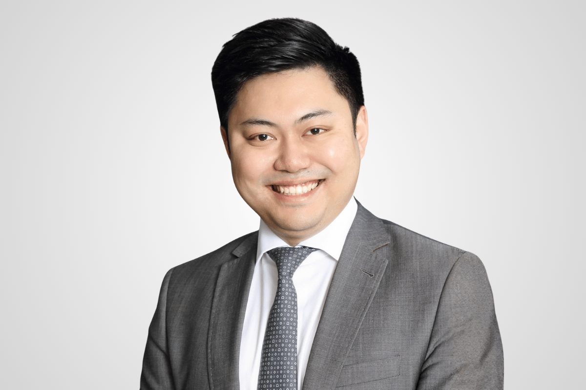 A professional portrait of Dennis Li
