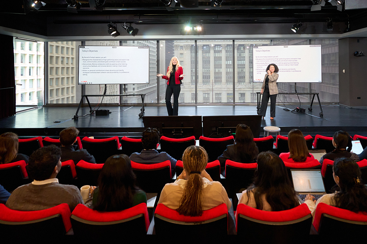 Morningstar employees attending a presentation led by colleagues in an auditorium.