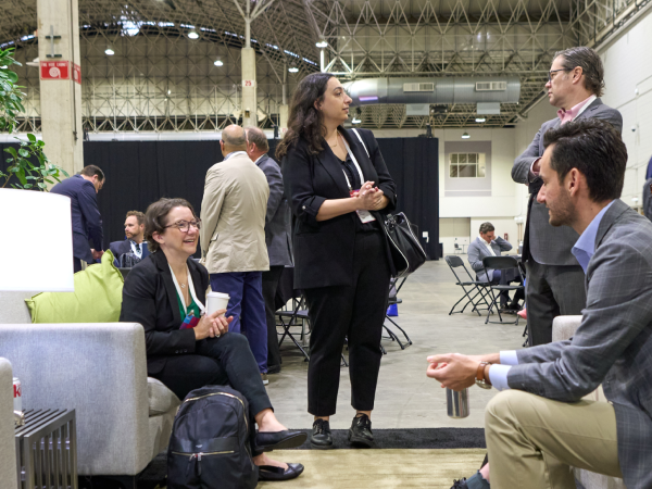 Image of people sitting and standing having a conversation.