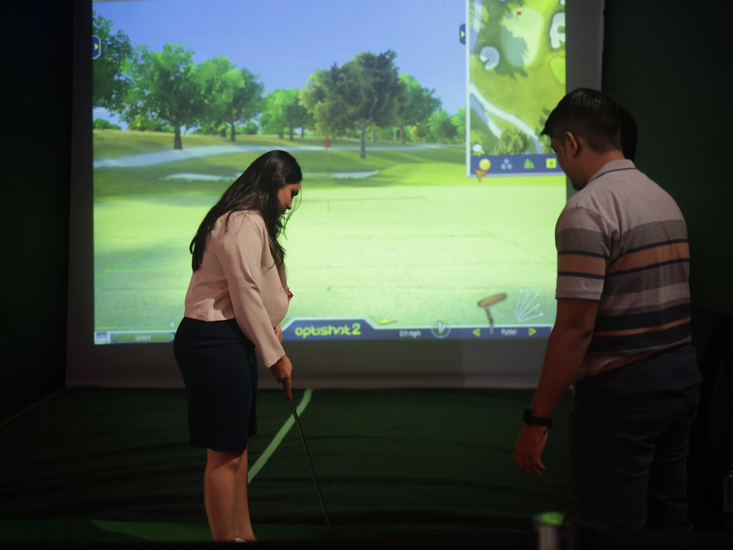 Attended playing simulated golf.