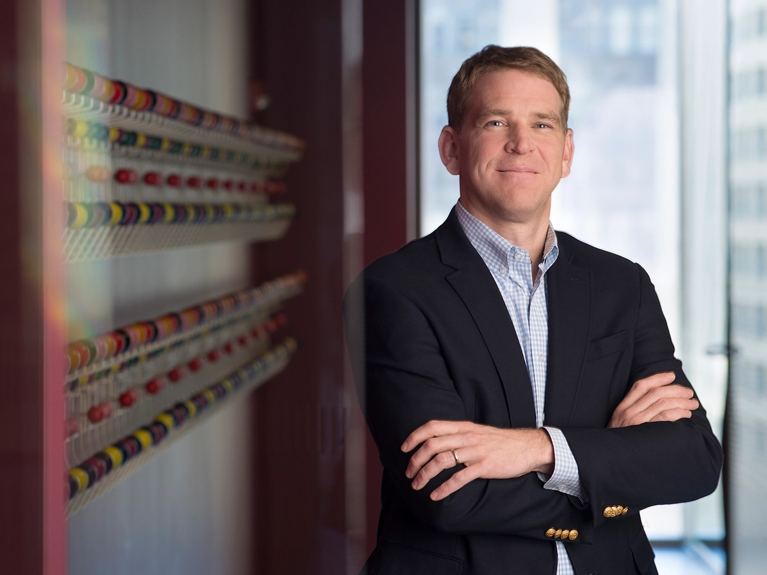 A professional portrait of Daniel Dunn in the Chicago Morningstar office.