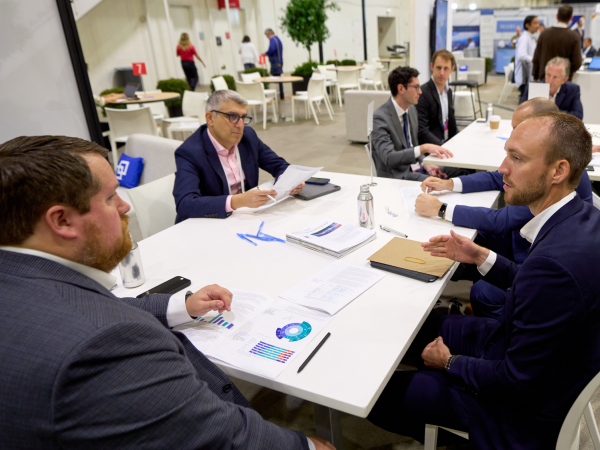 Image of Advisors sitting down on a table having a conversation.