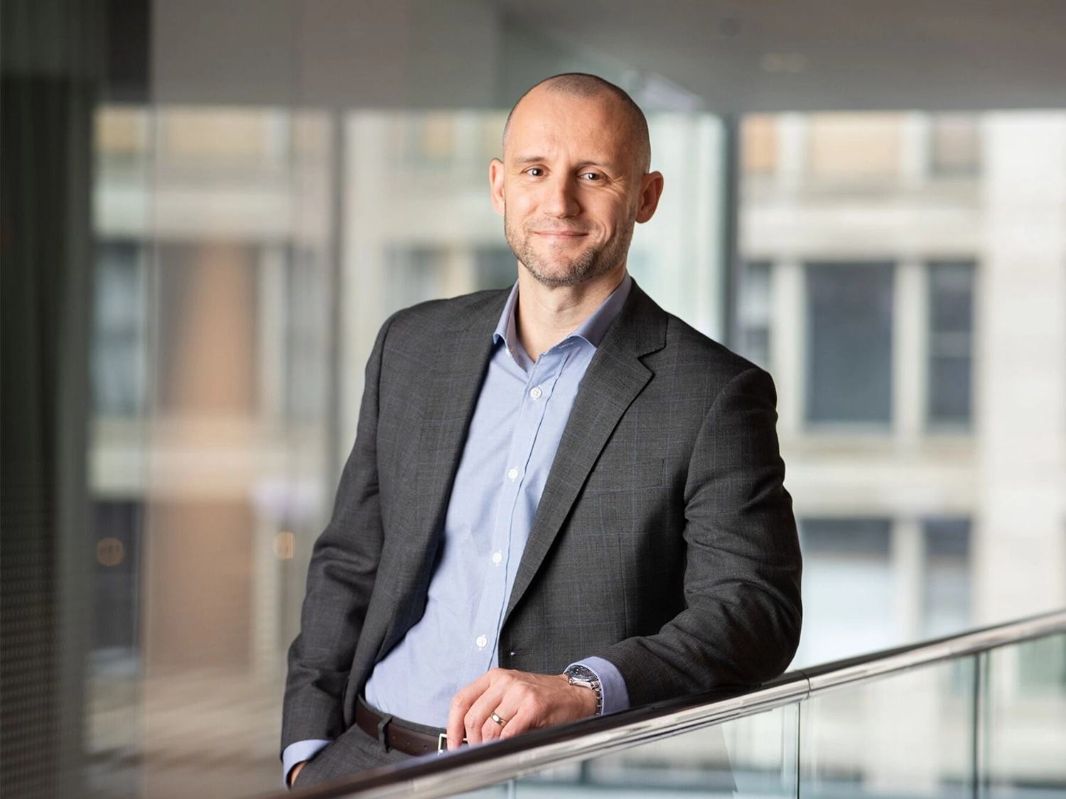 A professional portrait of Daniel Needham in the Chicago Morningstar office.
