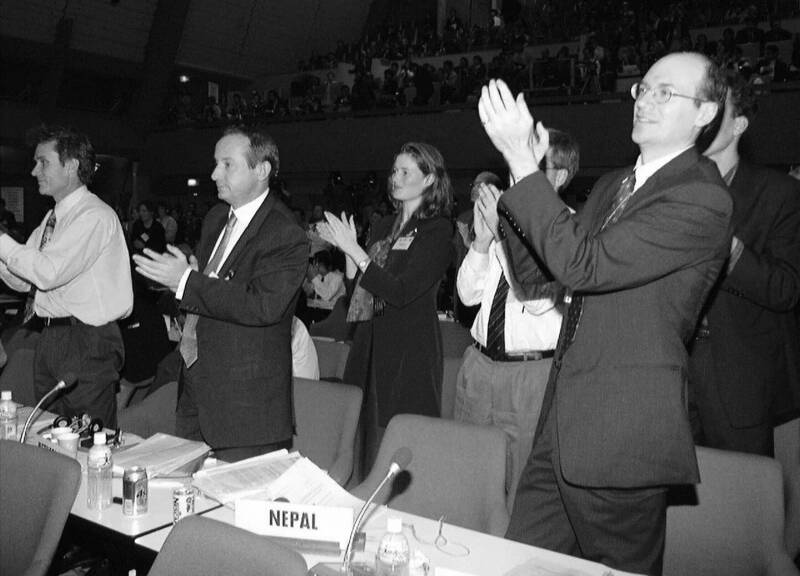 Photograph of representatives applauding as the Kyoto Protocol is adopted